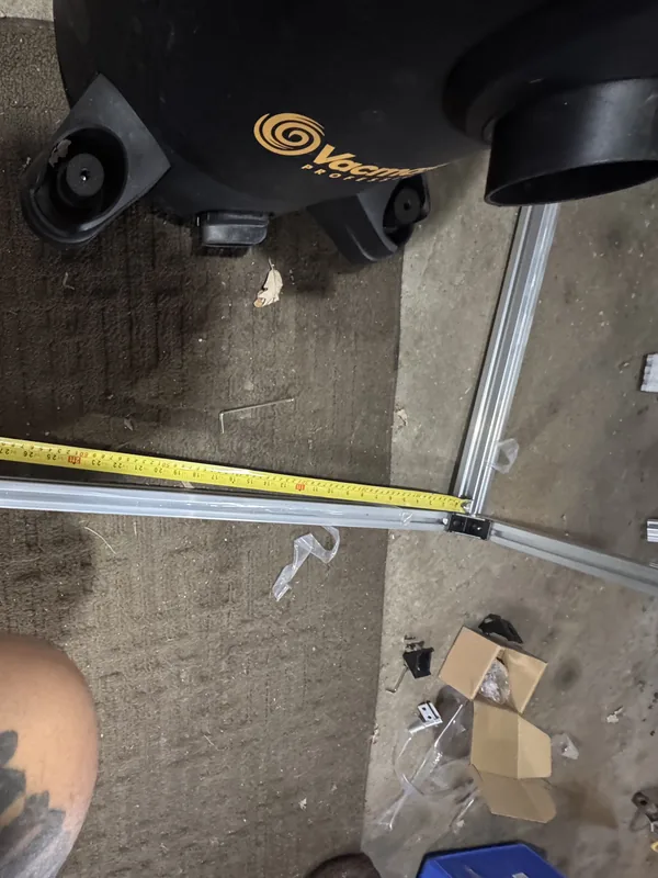 A tape measure stretched along the aluminum frame