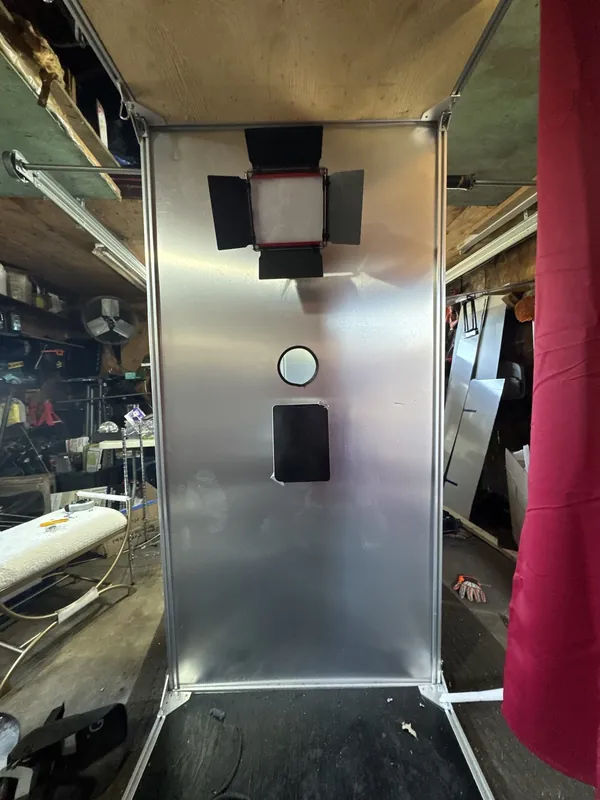 Brushed-metal equipment wall with the light, camera and screen openings