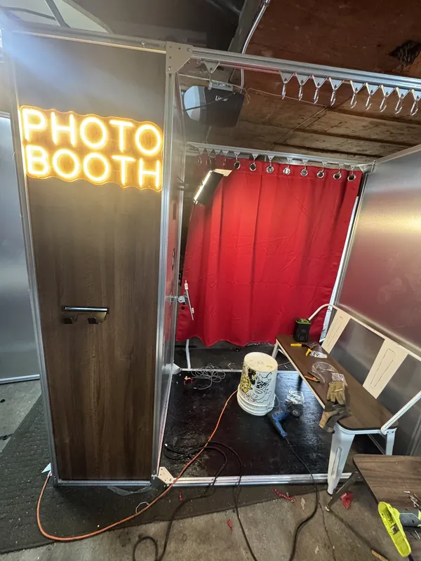 The PHOTO BOOTH neon sign lit for the first time in the garage