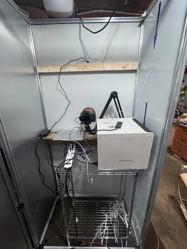The printer installed in the booth's cabinet