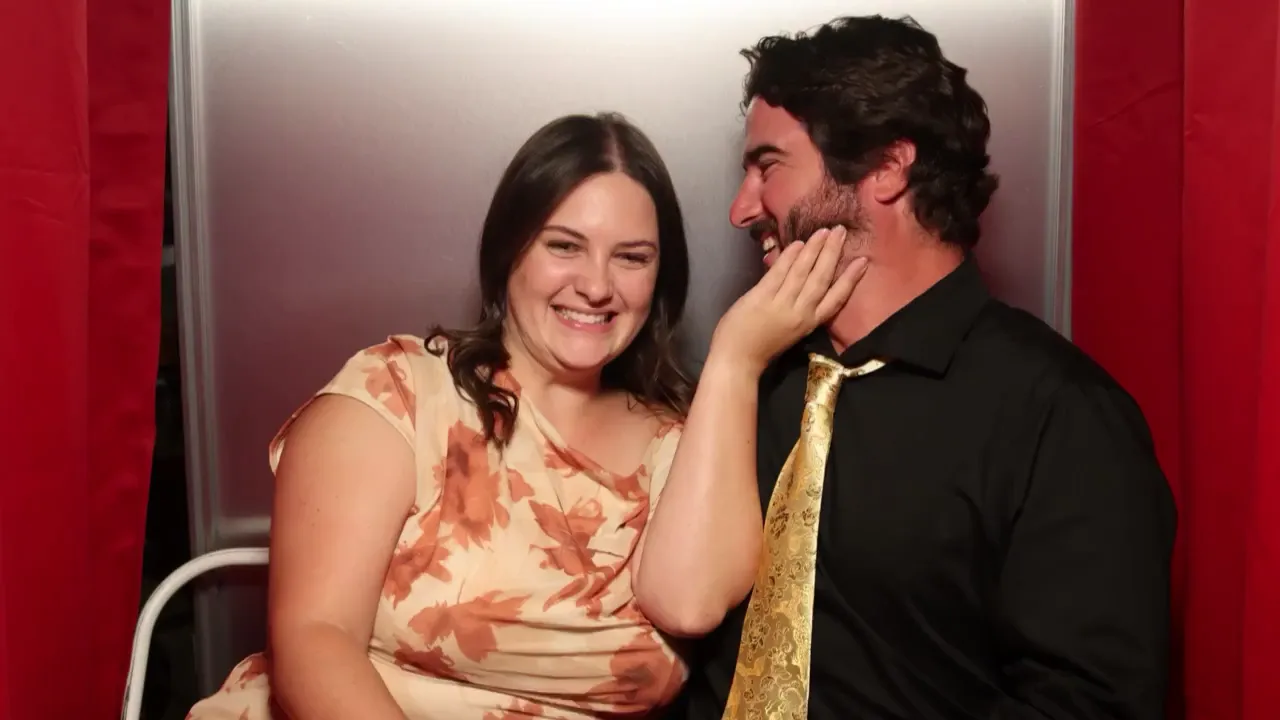 Wedding guests posing and laughing inside the Mo&rsquo;s Moments booth